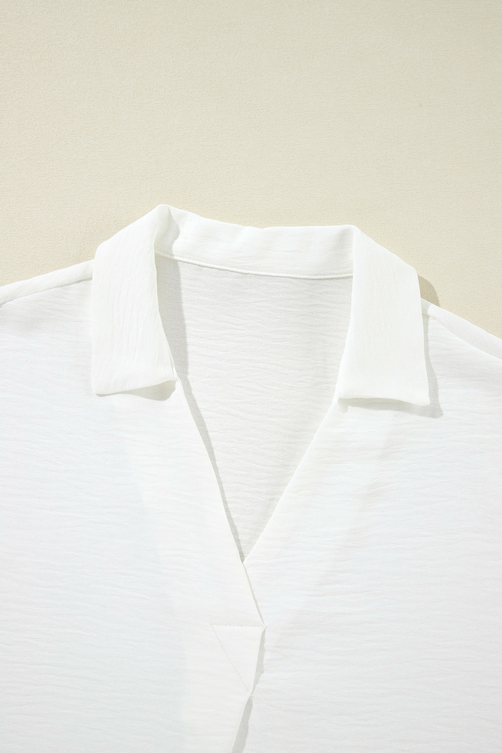 White boxy blouse with collar and smocked sleeve cuffs