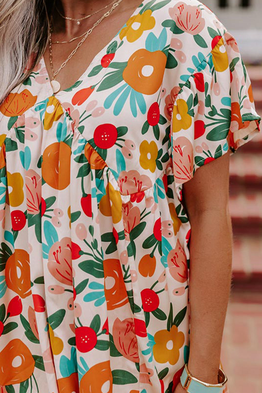 Apricot-colored blouse with short sleeves, V-neck and floral print