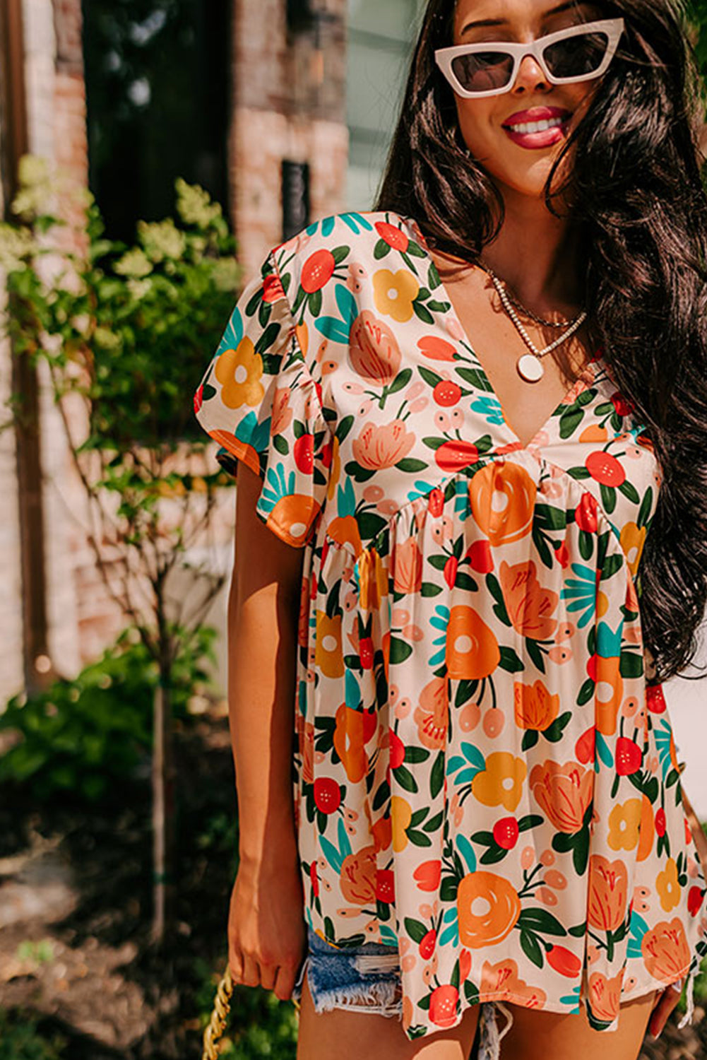 Apricot-colored blouse with short sleeves, V-neck and floral print