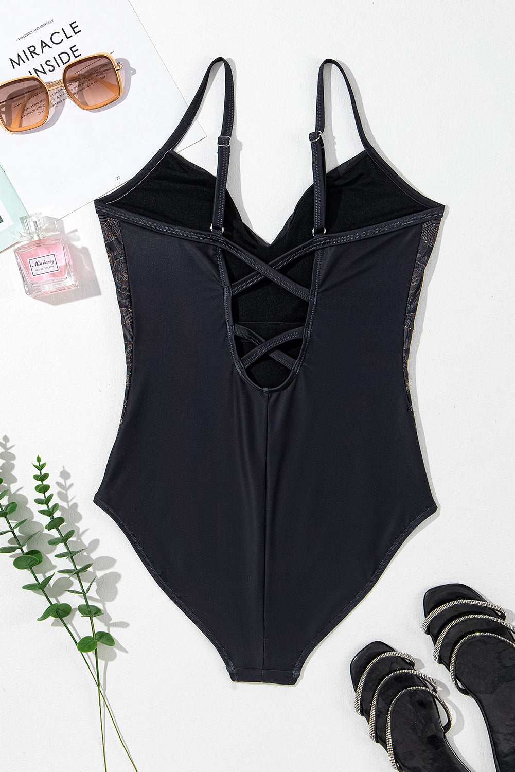 Black swimsuit with petal print and spaghetti straps