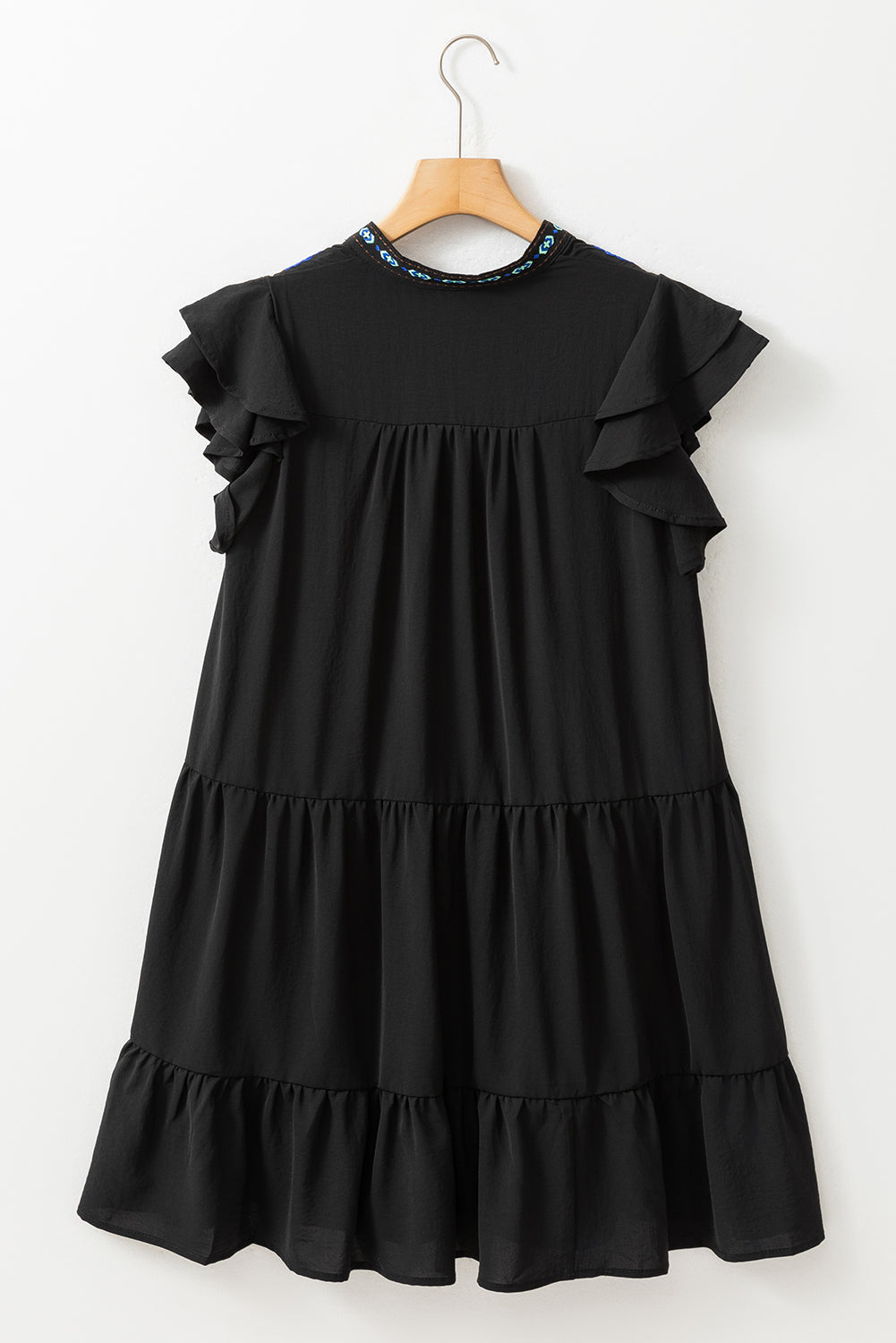 Black mini dress with embroidered flowers and layered ruffles