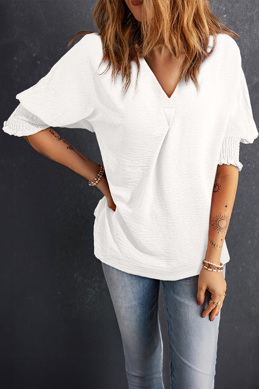 White boxy blouse with collar and smocked sleeve cuffs