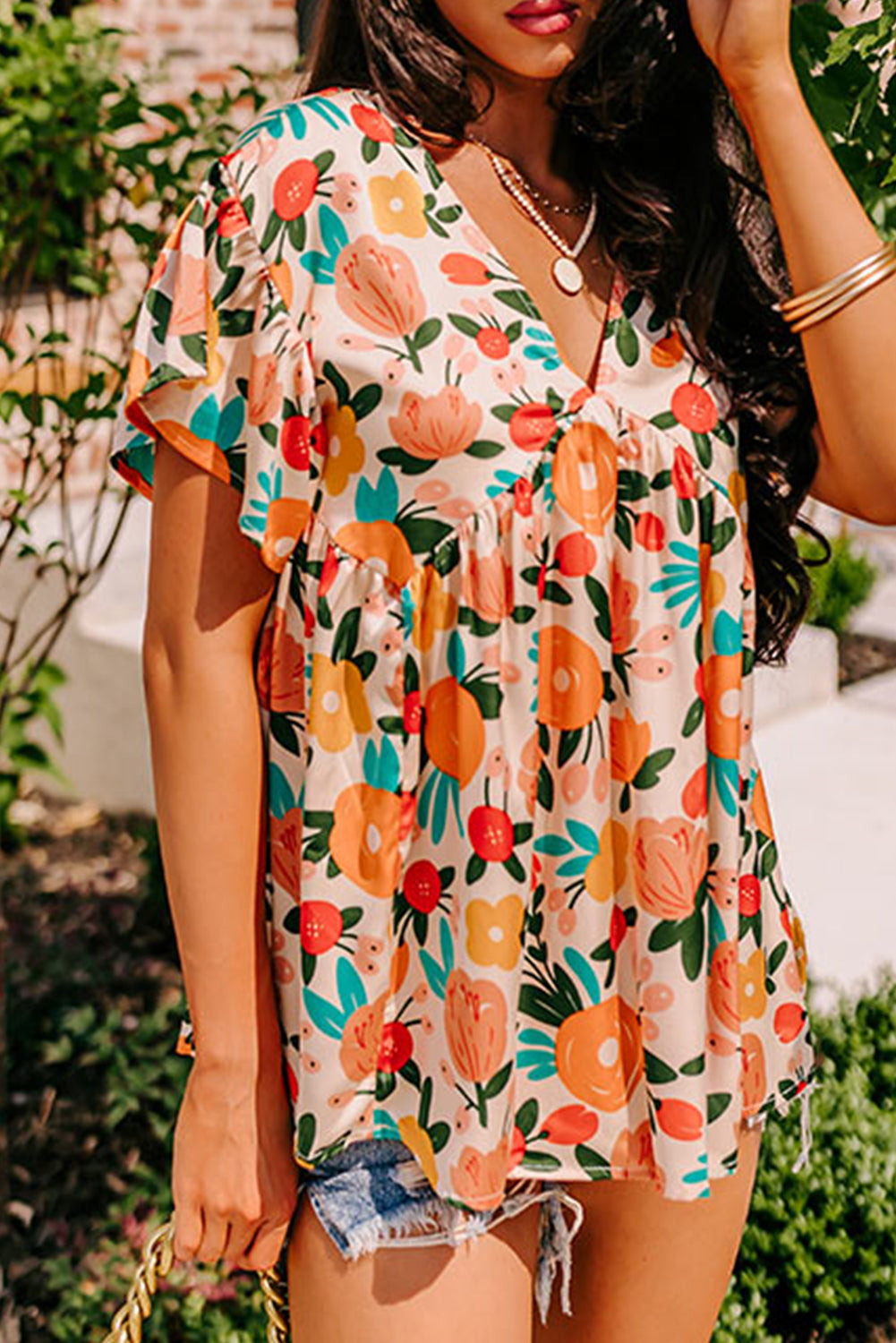 Apricot-colored blouse with short sleeves, V-neck and floral print