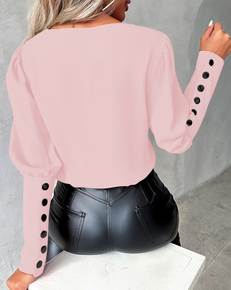 Fashionable V-neck blouse with long sleeves and button details