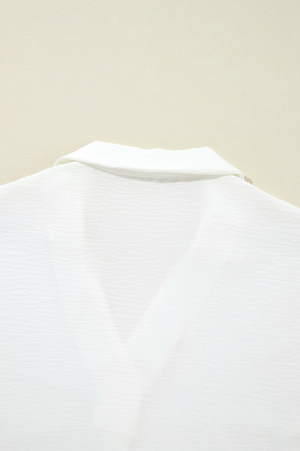 White boxy blouse with collar and smocked sleeve cuffs