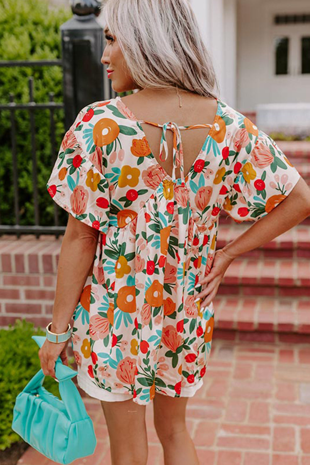 Apricot-colored blouse with short sleeves, V-neck and floral print