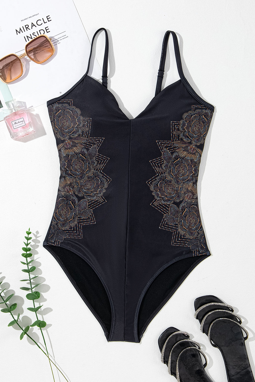 Black swimsuit with petal print and spaghetti straps