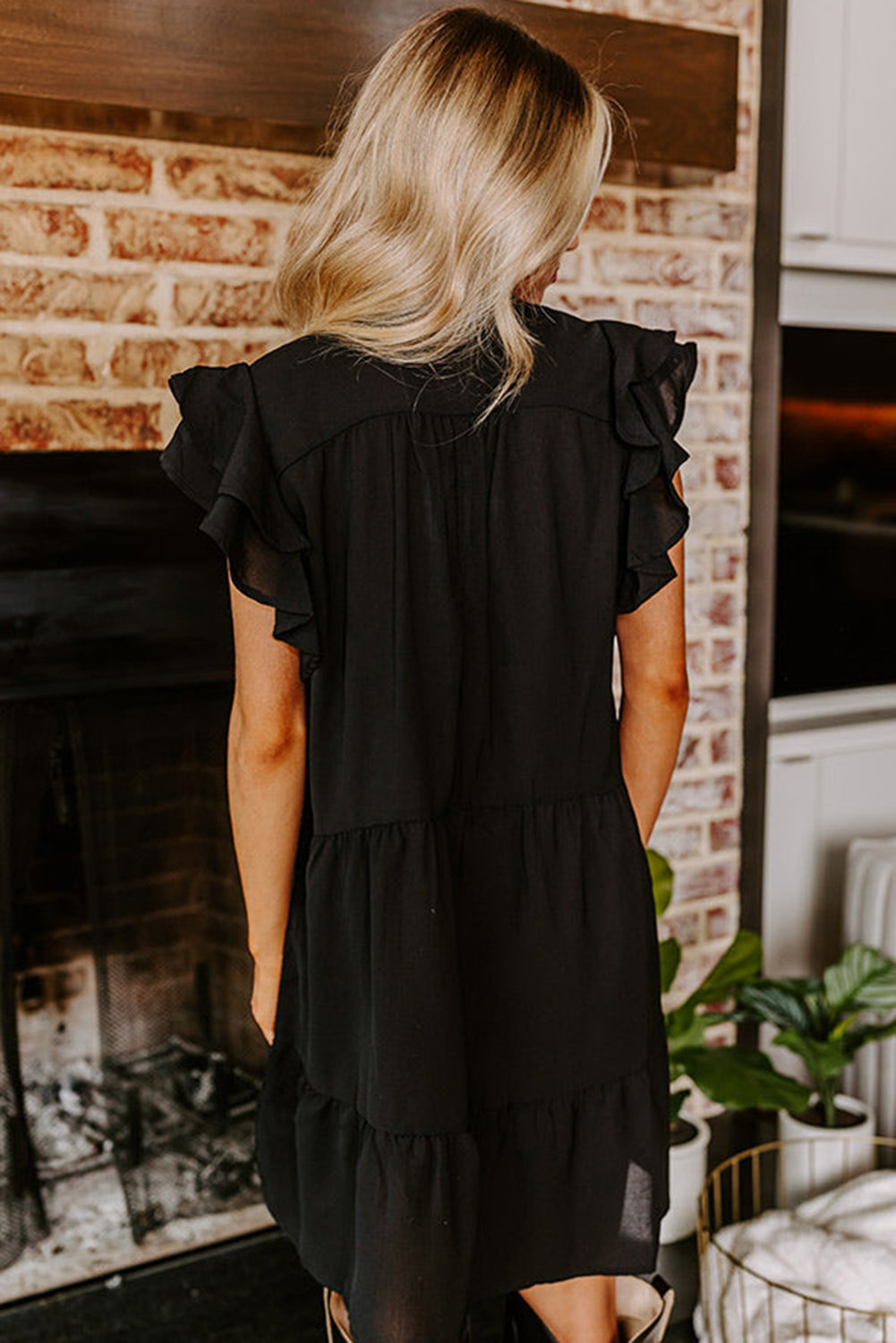 Black mini dress with embroidered flowers and layered ruffles