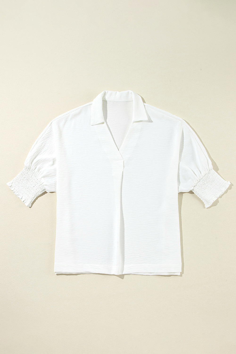 White boxy blouse with collar and smocked sleeve cuffs