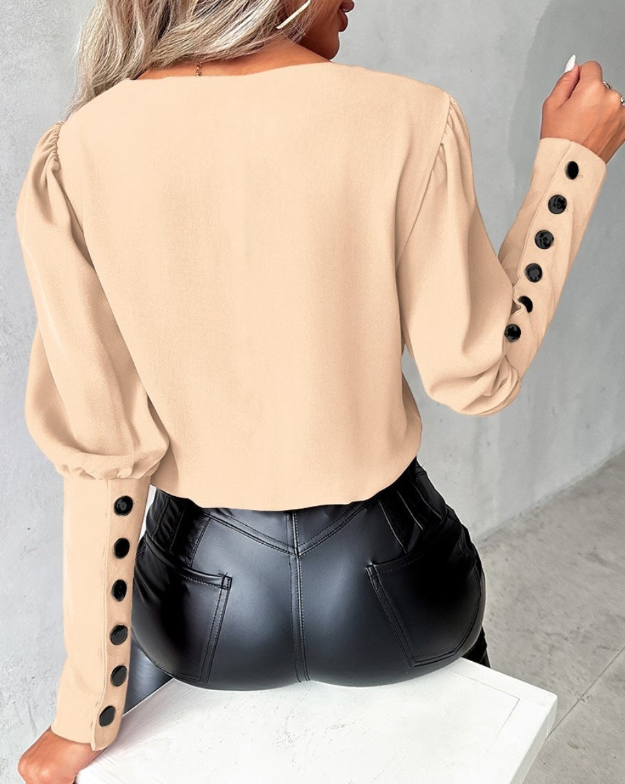 Fashionable V-neck blouse with long sleeves and button details