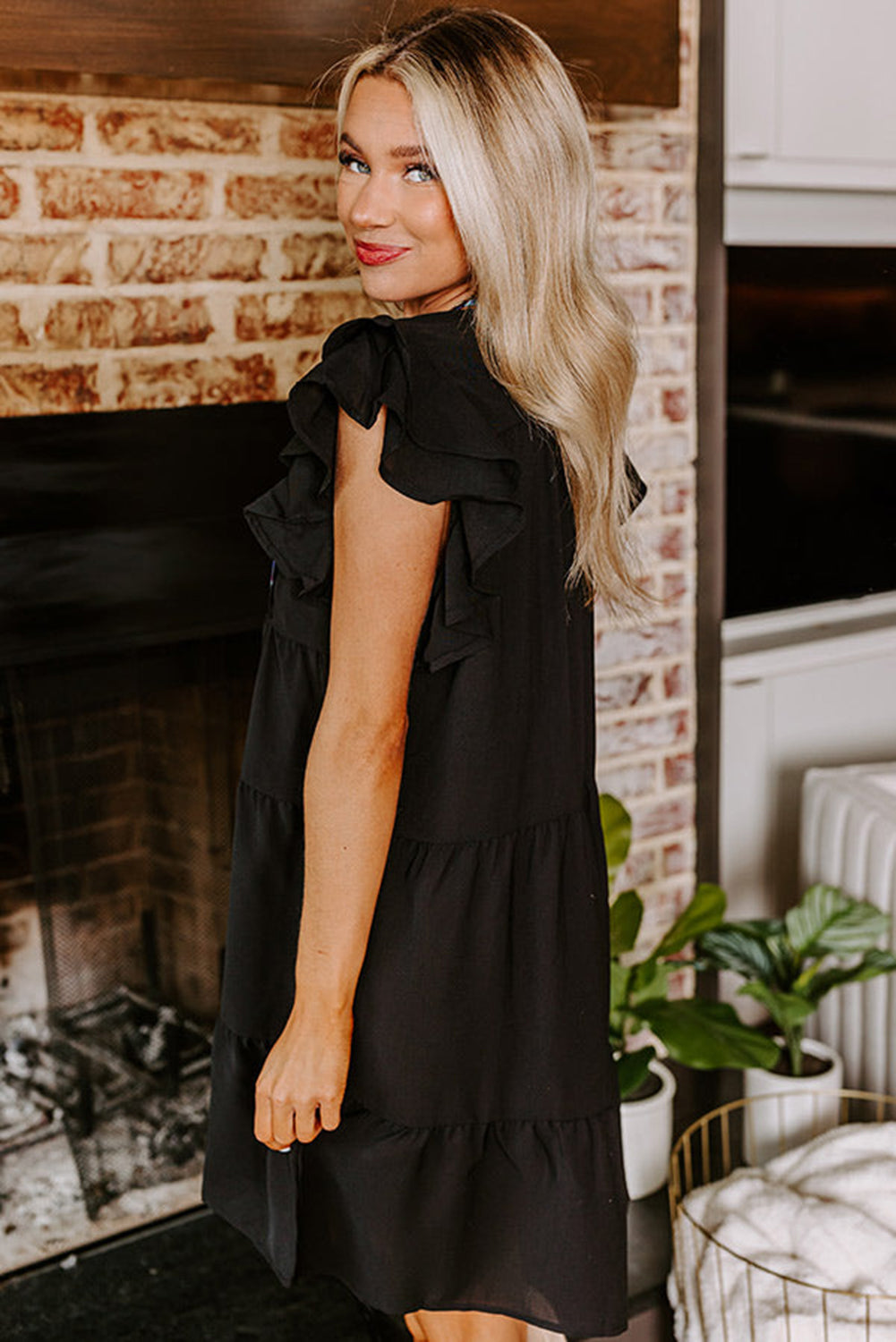 Black mini dress with embroidered flowers and layered ruffles